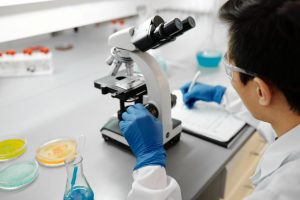 man looking through microscope