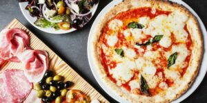 a pizza on a plate and a deli platter