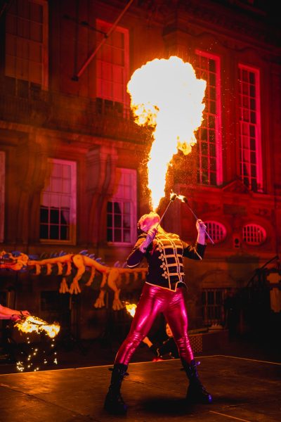man blowing fire out of his mouth on a stage