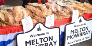 A market with melton mowbray signs in front of it