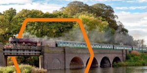A train going over a bridge with design elements to enhance it