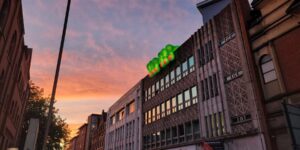 Giant green light up fingers on top of city centre building
