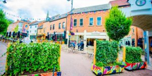 A busy city street with outdoor seating
