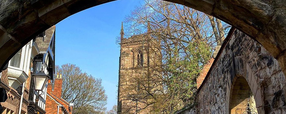 a church viewed through an old archway