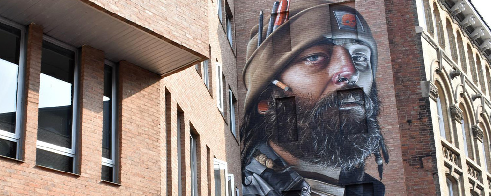 street art of a bearded man on the side of a building