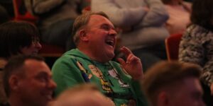 a man laughing in an audience