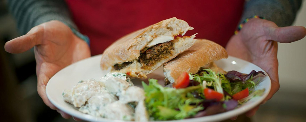 a sandwich on a plate with a salad