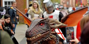 A man riding a dragon with a traditional knights outfit