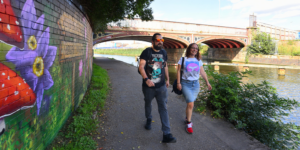 two people walking along a canal