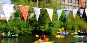Bunting over a river with kayakers on it
