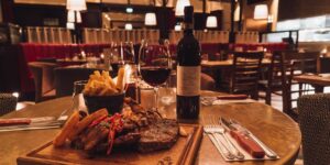 A steak dinner and wine in an intimate restaurant