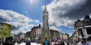 Leicester clock tower in the busy high street area with many shoppers