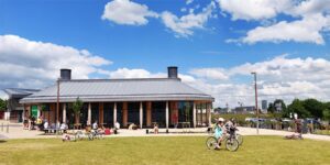 people cycling around an outdoor cafe space
