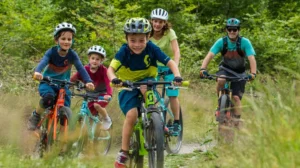 family cycling together with helmets on