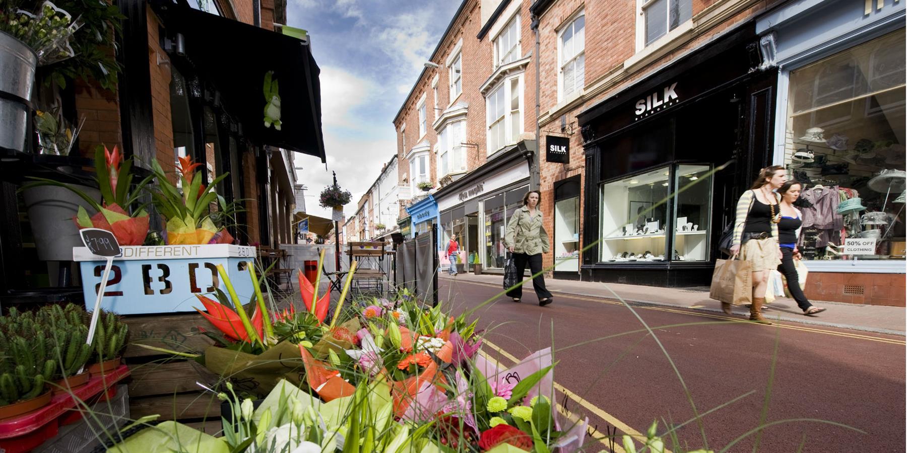 Shopping street with flowers showing a vibrant scene