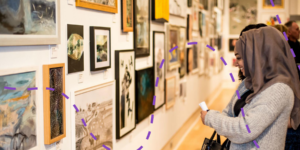 A woman admiring artwork in a gallery