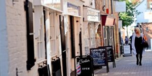 A shopping street with a woman looking in the windows