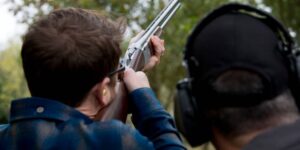 man holding a clay shooting gun