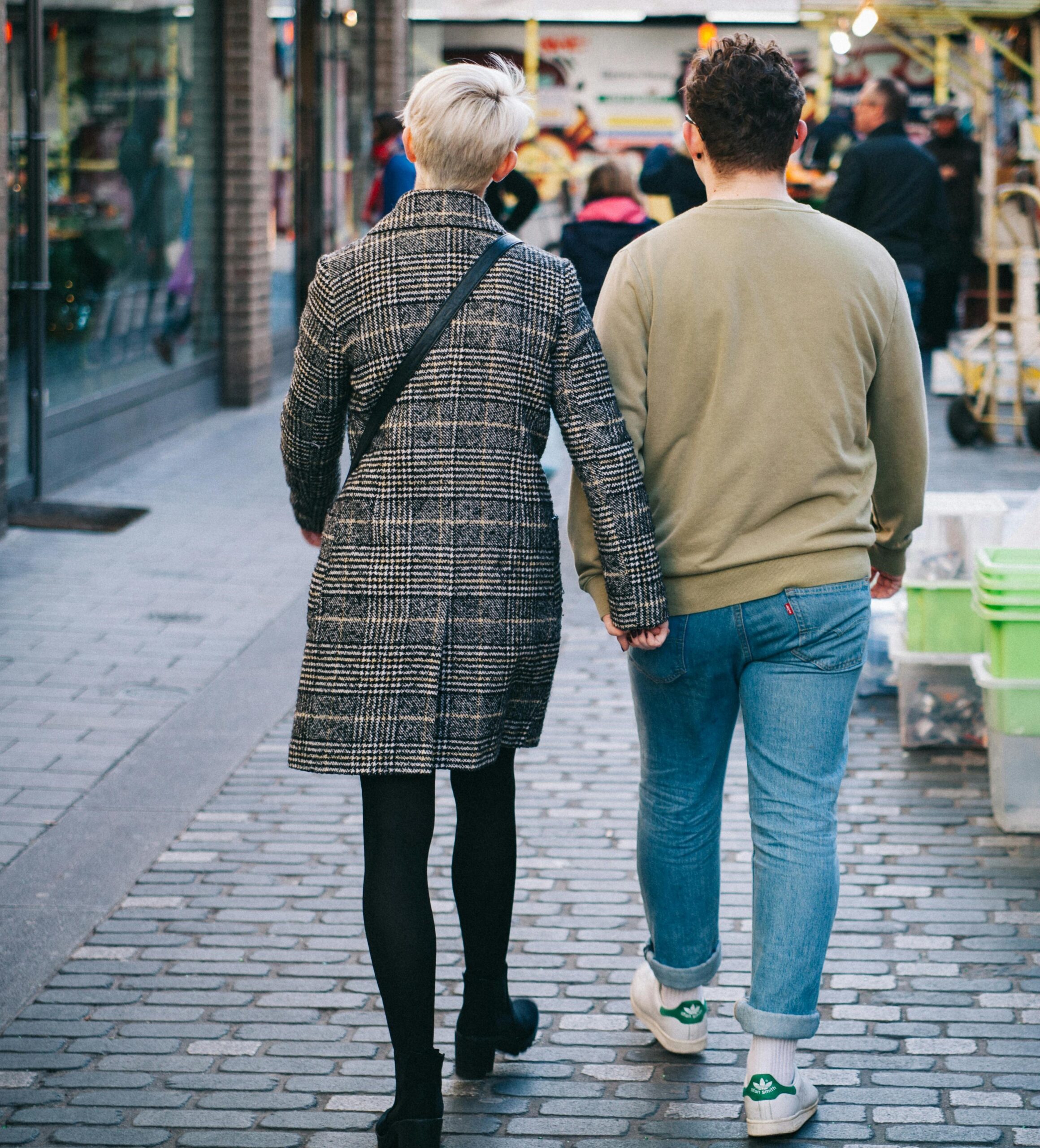 two people walking in a shopping area