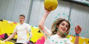 Woman throwing a dodgeball at an activity centre