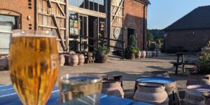 outdoor seating with a rustic feel and a pint of lager