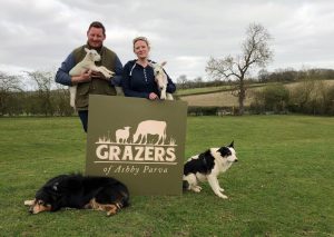 two people holding lambs