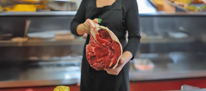 Woman holding piece of beef