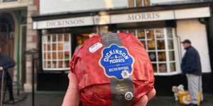 pork pie being held up in front of a shop