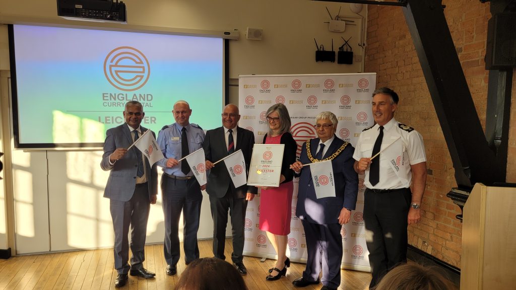 delegates celebrate Leicester being named England's Curry Capital at the KRIII Centre
