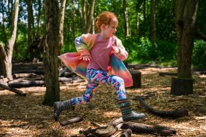 girl running through a wood