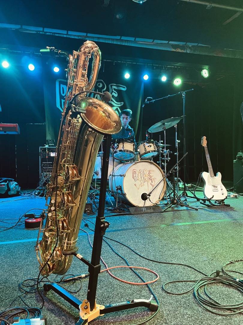 A saxophone and drummer on stage