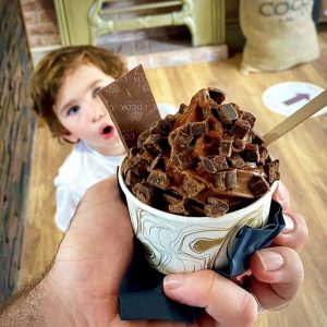 A child looking at a chocolate cup