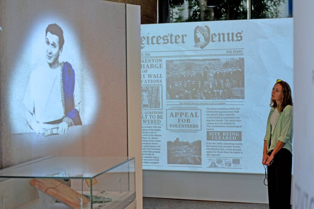 A person looking at a display in the Jewry Wall Museum