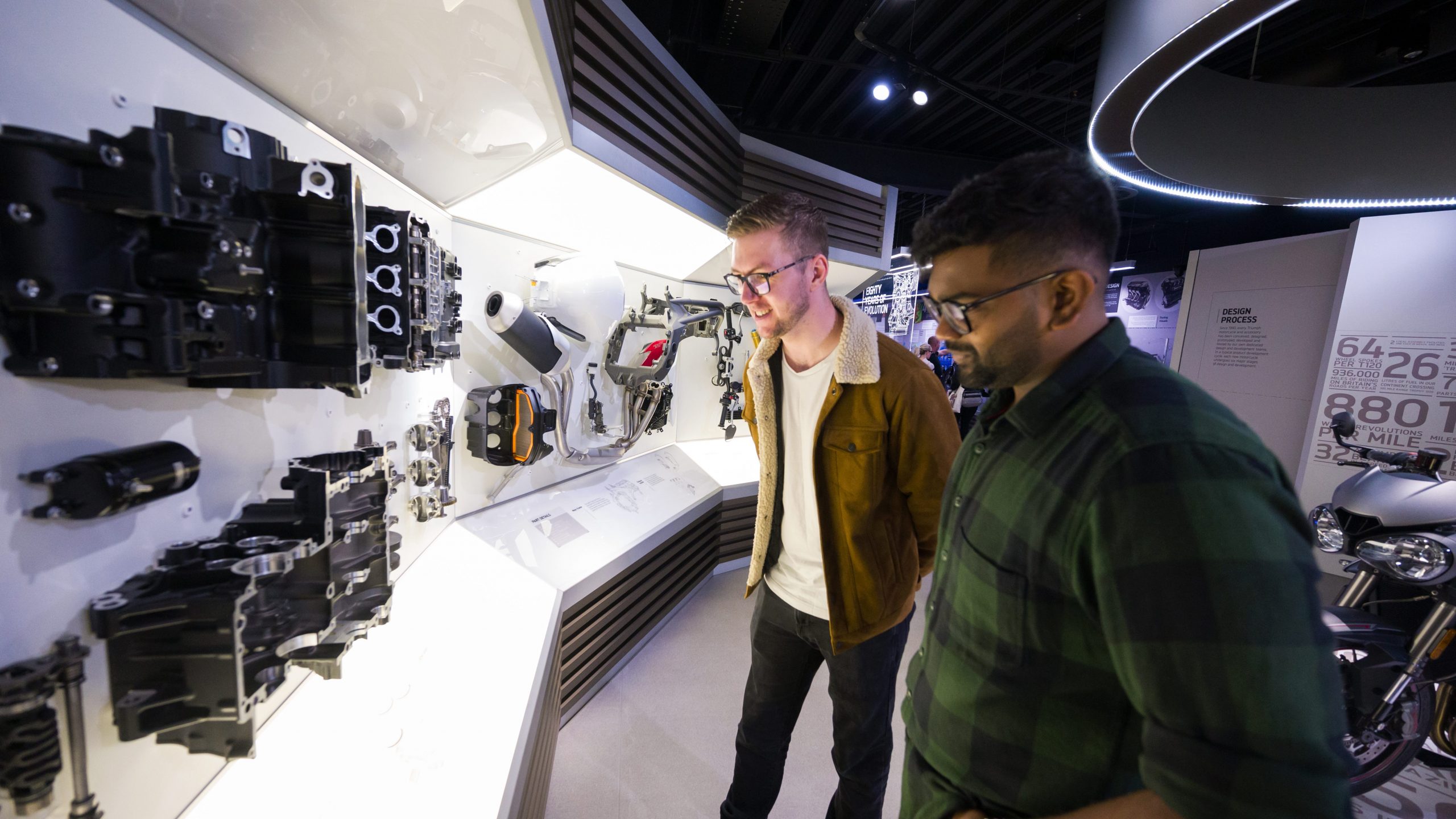 Two men looking at the exhibits in the Triumph Factory Visitor Experience