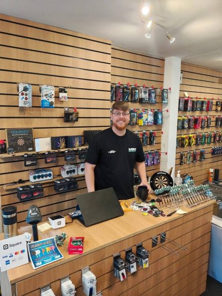 A man behind the counter at Darts Unlimited