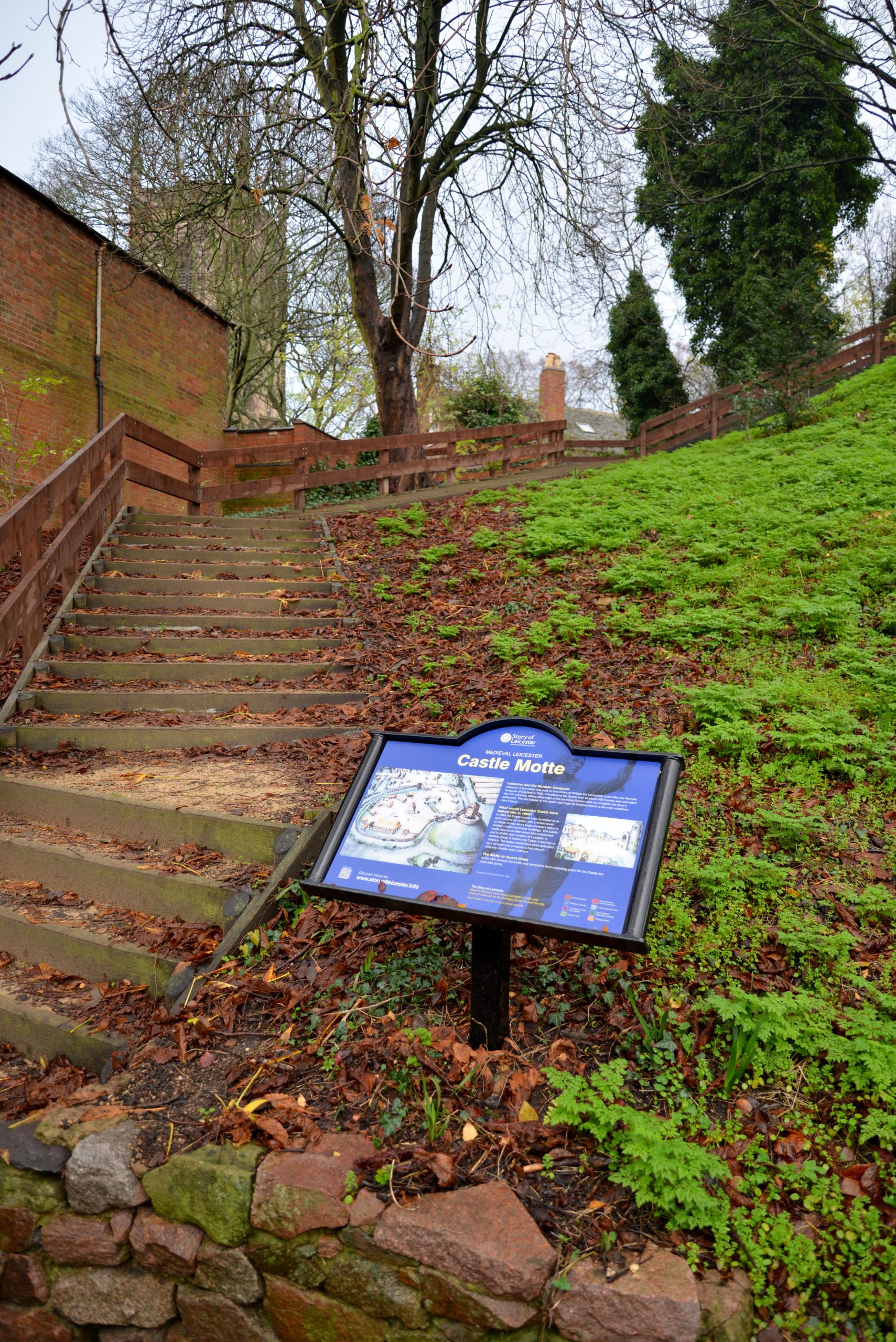 outdoor sign next to a hill