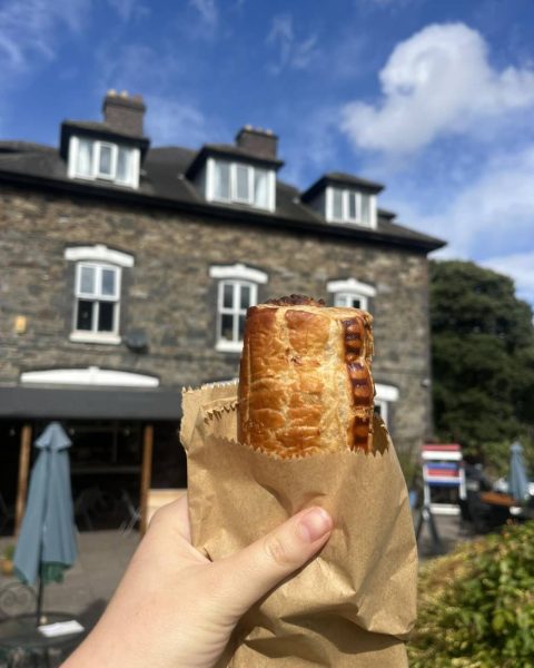 A sausage roll in front of the tearoom
