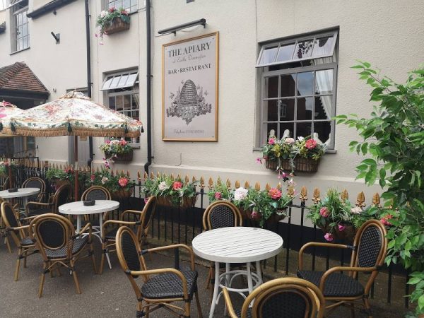 The exterior of the Apiary with tables