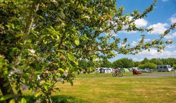 Campsite and person riding a bike